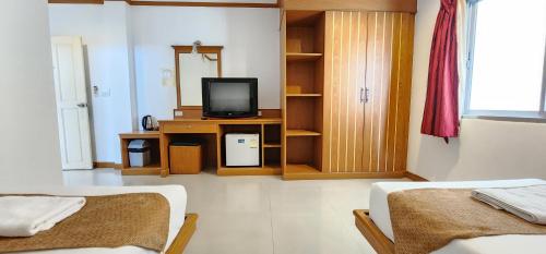 a living room with two beds and a television at Eden Park in Patong Beach