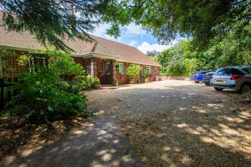 a house with cars parked in front of a driveway at Cosy Annex, Close to Beach with Parking in Torquay