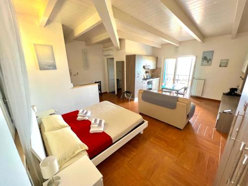 a living room with a bed and a couch at TRAMONTO Suite-Rome Airport FCO-Fronte mare in Fiumicino