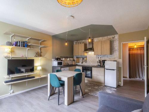 une cuisine et un salon avec une table et des chaises dans l'établissement Appartement spacieux à Gourette, 8 pers, 2 ch, entrée station, bien équipé, casier à skis - FR-1-400-113, à Eaux-Bonnes