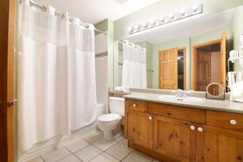 a bathroom with a toilet and a sink at Whistler Vacation Club at Twin Peaks in Whistler