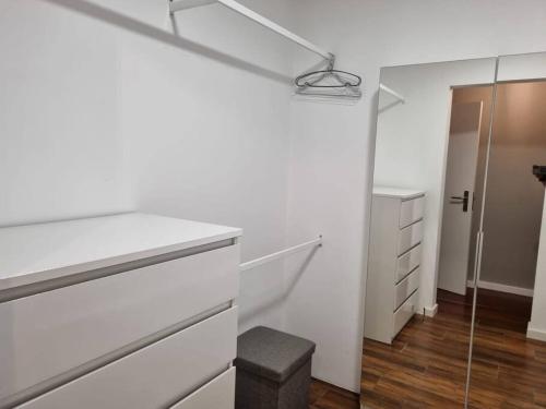 a white kitchen with a sink and a mirror at Olimpia Gardens View by Rentallido in São Gonçalo