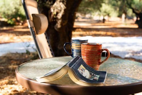a table with two coffee cups and a spoon at Thalassa Green in Agios Nikolaos