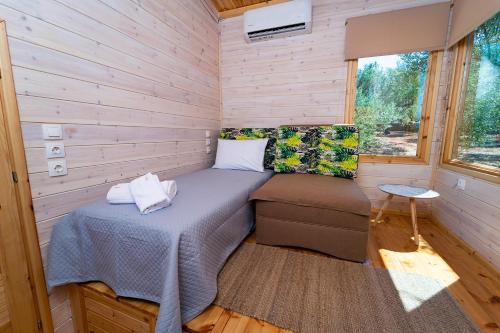 a bedroom in a tiny house with a bed and a window at Thalassa Green in Agios Nikolaos