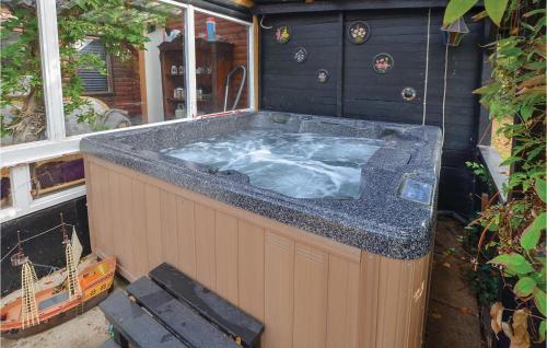 a jacuzzi tub sitting inside of a house at Nice Home In Sydals With Wifi in Østerby
