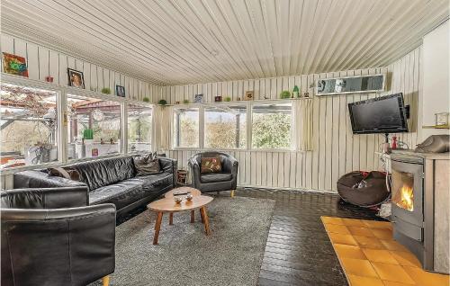 a living room with a couch and a fireplace at Nice Home In Sydals With Wifi in Østerby
