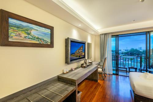 a living room with a bed and a large window at Treepana Boutique Hotel, Huahin in Hua Hin