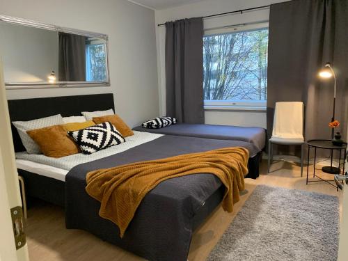 a bedroom with two beds and a window at 2BR Apartment, free parking - Peikontie in Oulu