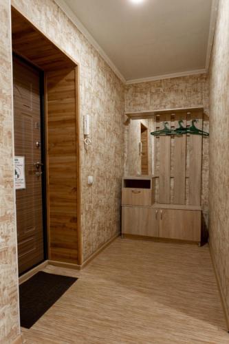 a bathroom with a wooden door in a room at Амарант in Petropavlovsk