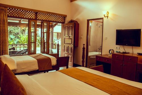 a hotel room with two beds and a television at Lake View Resort in Pokhara