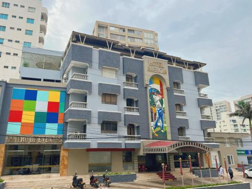 a building with a colorful mural on the side of it at Hotel American Golf in Barranquilla