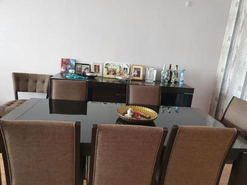 a dining room table with chairs and a table with a bowl on it at Bostanlı Sahile Yakın 2+1 Daire in Karşıyaka