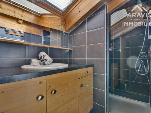 a bathroom with a sink and a shower in a room at Chalet Le Grand-Bornand, 5 pièces, 8 personnes - FR-1-391-8 in Le Grand-Bornand