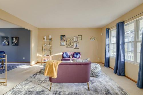 a living room with a purple couch and a window at Cozy Winter Retreat with Modern Minimalist Charm in Omaha