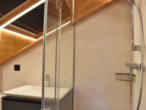 a shower with a glass door in a bathroom at Confort et commodités à Méribel Village, 3 chambres, balcon sud, parking couvert, à 150m des remontées - FR-1-180-528 in Chandon