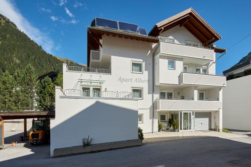 a white building with a sign on it at Apart Albert in Ischgl
