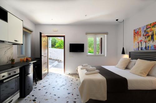 a bedroom with a large bed and a television at Blue Sky House in Pylos