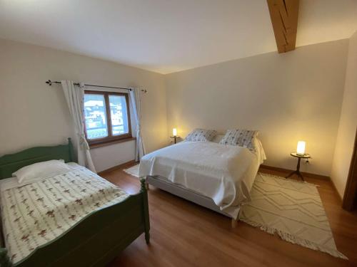 a bedroom with two beds and a window at Appartement spacieux 9 pers à Beaufort avec balcon, 4 chambres et équipements familiaux - FR-1-342-289 in Beaufort