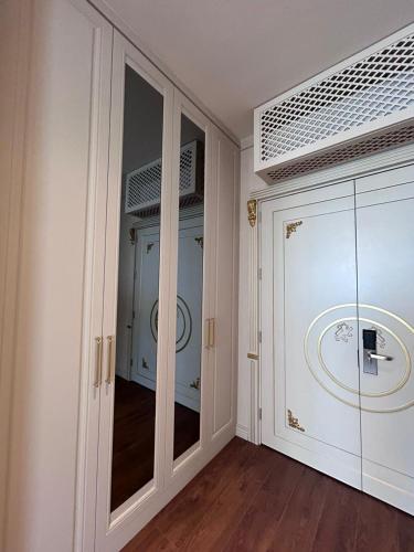 a room with a glass door and a hallway at King Sky Tower Hotel in Batumi