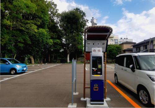 a parking meter next to a white van in a parking lot at 心遊亭Shin Yu Tei 一軒雅宿 in Kanazawa
