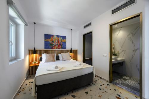 a bedroom with a large bed and a bathroom at Blue Sky House in Pylos