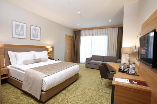 Ένα ή περισσότερα κρεβάτια σε δωμάτιο στο Mia City Hotel