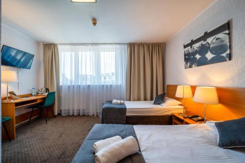 A bed or beds in a room at Hotel Gromada Poznań