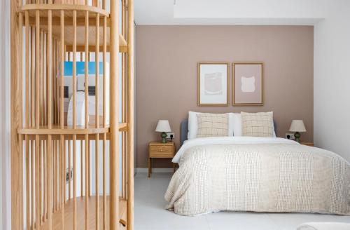 a bedroom with a bed and a wooden ladder at The Majestic Mile 1BR Apartment in Singapore! in Singapore