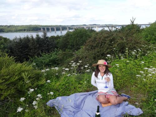 a young girl sitting on a blanket in the grass at Casa Mundo Bed & Breakfast in Vejle