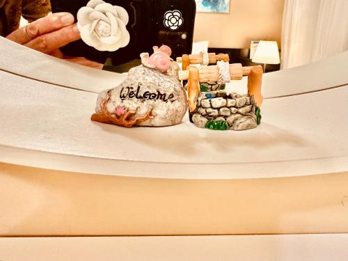 a toy pig sitting on top of a cake at Scorpion Hiuse Langley -ROOM A in Langley
