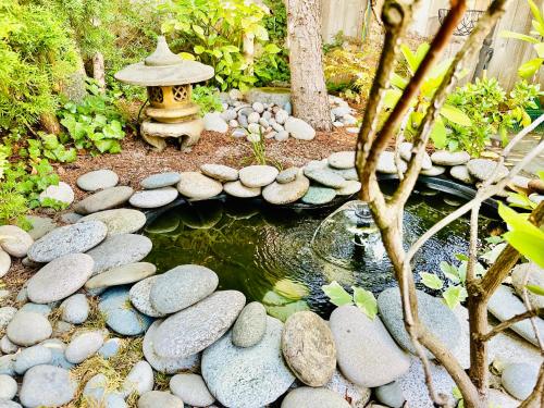 a pond with a fire hydrant in a garden at Scorpion Hiuse Langley -ROOM A in Langley