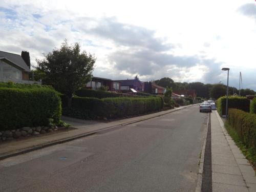 a street with houses and a car parked on the road at Casa Mundo Bed & Breakfast in Vejle