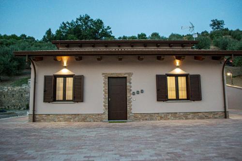 a small house with two windows and a door at L'Antica Fontana - Casa Vacanze B&B in Viggianello