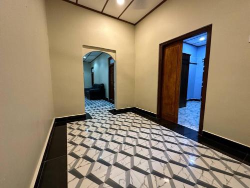 an empty hallway with a door and a tile floor at Villa in Kalviyankadu in Irupalai