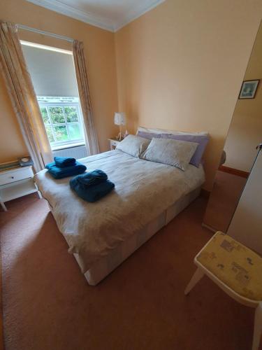 a bedroom with a bed with two towels on it at Lily's Place - up to 4 persons in Birr