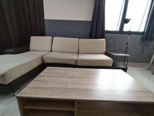 a living room with a couch and a coffee table at Icon Residenz Icon City, Petaling Jaya by De Harlequins Guesthouse in Petaling Jaya