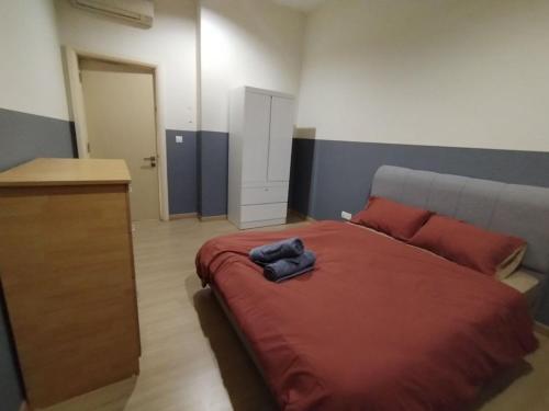 a bedroom with a large bed with a red blanket at Icon Residenz Icon City, Petaling Jaya by De Harlequins Guesthouse in Petaling Jaya