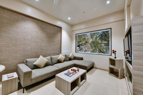 a living room with a couch and a table at Click Hotel Pithampur in Mhow