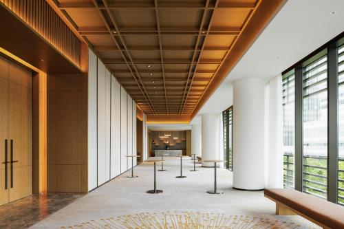a hallway in a building with windows and a lobby at The Westin Yokohama in Yokohama