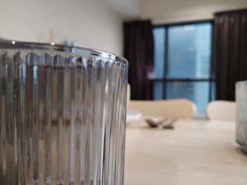 a close up of a glass on a table at Icon Residenz Icon City, Petaling Jaya by De Harlequins Guesthouse in Petaling Jaya