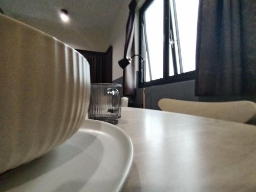 a bowl sitting on a table with a glass at Icon Residenz Icon City, Petaling Jaya by De Harlequins Guesthouse in Petaling Jaya