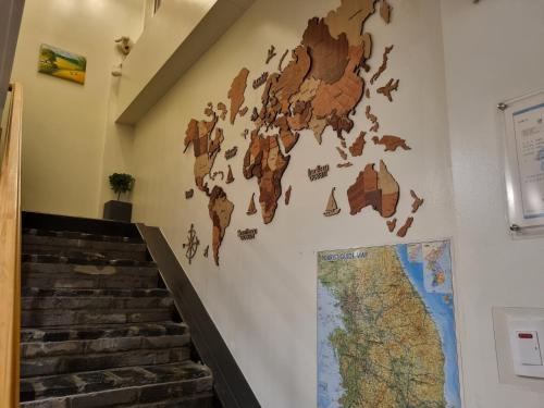 a wall mural of a map of the world on a wall at Sokcho Hutte in Sokcho