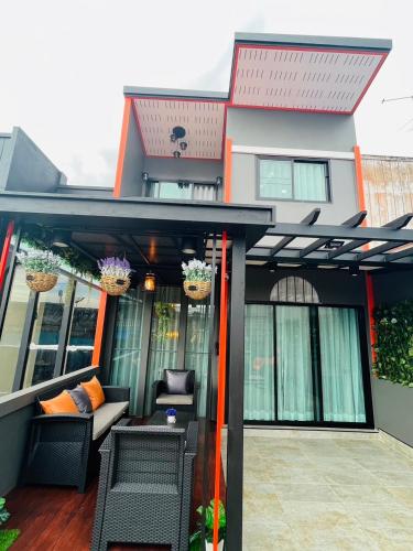 a screened in porch of a house at Kitjamyhome1 in Hat Yai