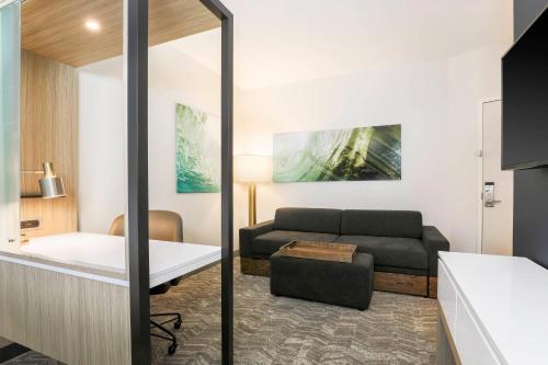 a living room with a couch and a table at SpringHill Suites by Marriott Tallahassee North in Tallahassee
