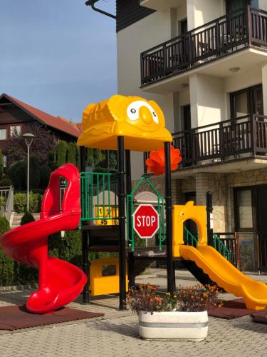 a playground with a slide and a stop sign at Danijela & konak in Zlatibor
