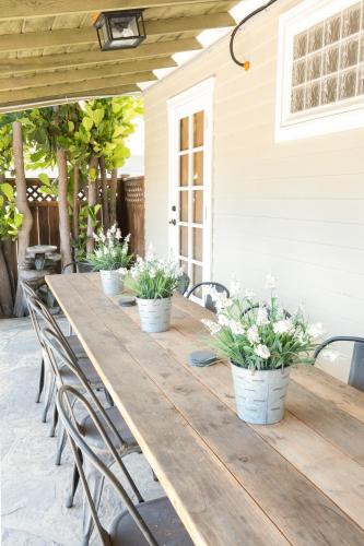 a long wooden table with chairs and potted plants at 4221 Urban oasis in Hillcrest Mission Hills in San Diego