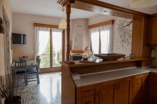 a kitchen with a counter with a sink in it at Άγρια Λούλουδα Κατοικία Ευτυχία in Timfristós