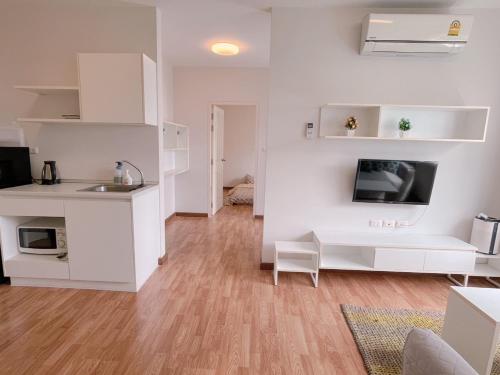 a white kitchen with a sink and a desk at Hua hin The Trust condo by Wila in Hua Hin