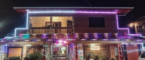 a building with purple and purple lights on it at The Layover - 6 mins from the airport, Fully equipped for short and long stays in Kelly Village