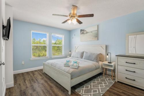 a bedroom with a bed and a ceiling fan at 7654 Shadow Lake Drive - Ocean's Eleven in Panama City Beach